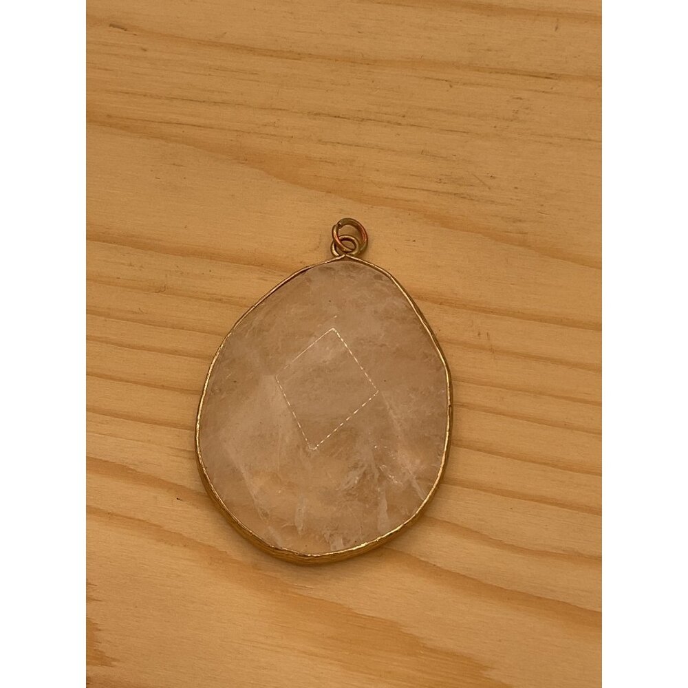 Clear Quartz Crystal Pendant Set In A Gold Colored Frame